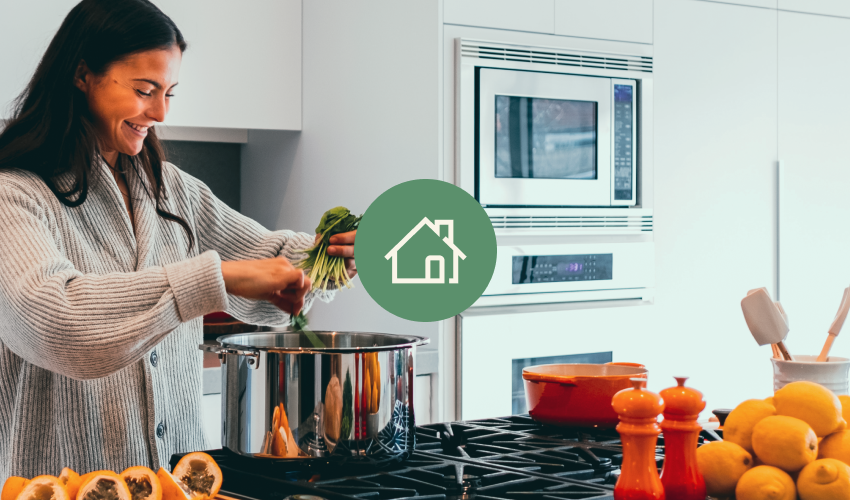 Small house icon over image of woman cooking on propane cooktop.